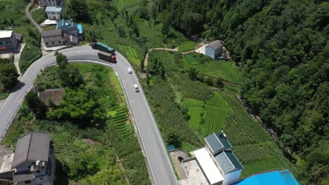 low aerial shot over winding roads with cars driving in hebei province, china