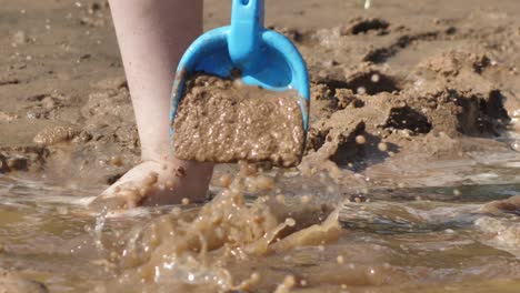 the child was playing with wet sand