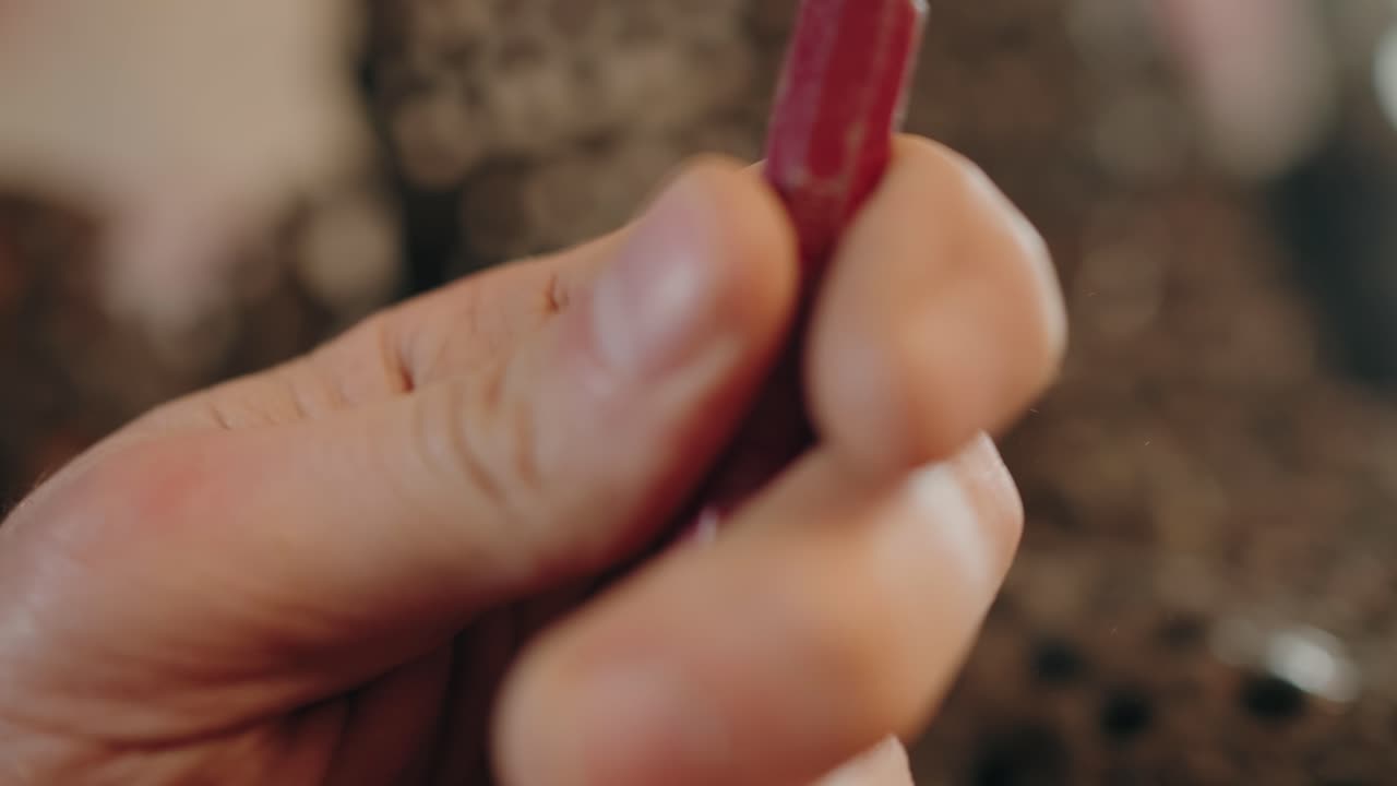 close up hammer striking metal in rustic artisan workshop