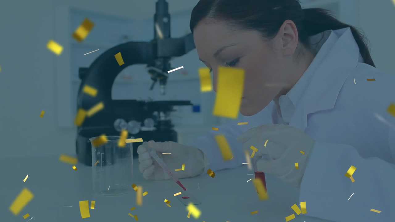 female scientist pipetting red liquid onto slide in laboratory, featuring floating gold confetti
