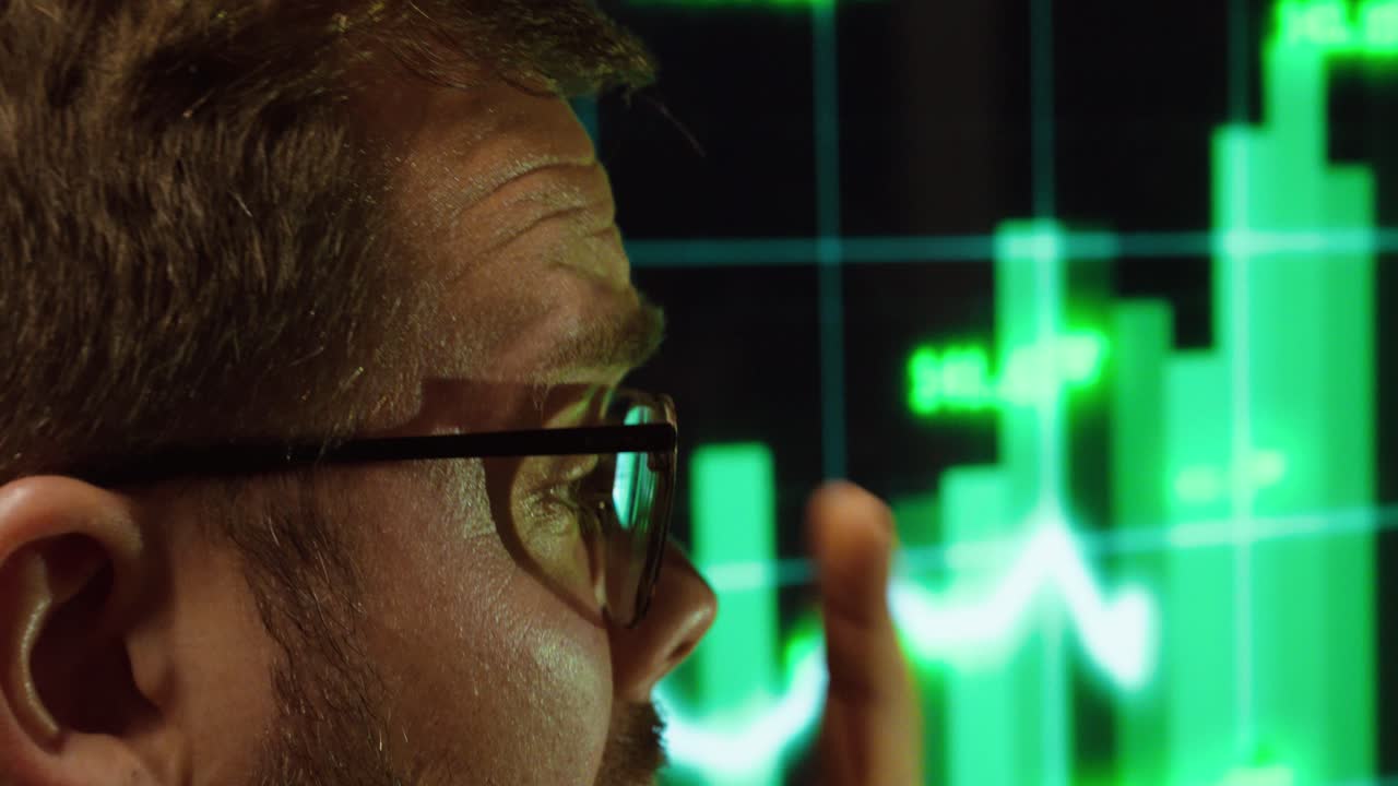 A man reacts emotionally to the rapidly rising stock market data. Concept of success, excitement, and financial gains in trading