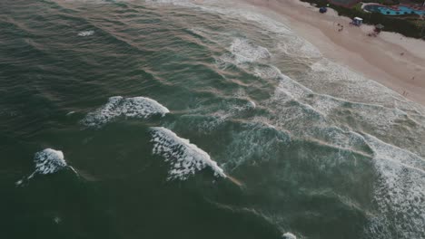a bird's eye view of brava beach in florianopolis, brazil, with waves breaking on the shore during sunset