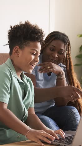 mother and child using laptop together