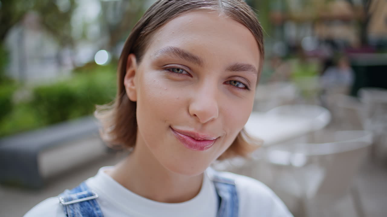 Portrait happy model face looking camera with carefree smile. Attractive woman