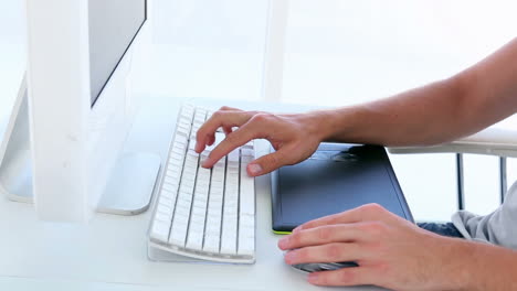 Graphic-designer-using-digitizer-at-his-desk