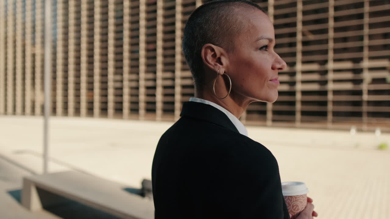 Confident Businesswoman with Shaved Head Holding Coffee Cup in City