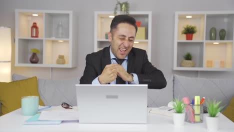 home office worker man experiencing joy looking at camera.