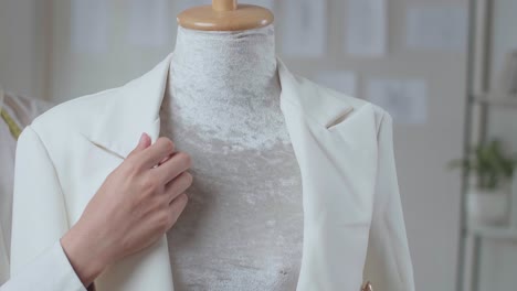 fashion designer is wearing clothes on mannequin model