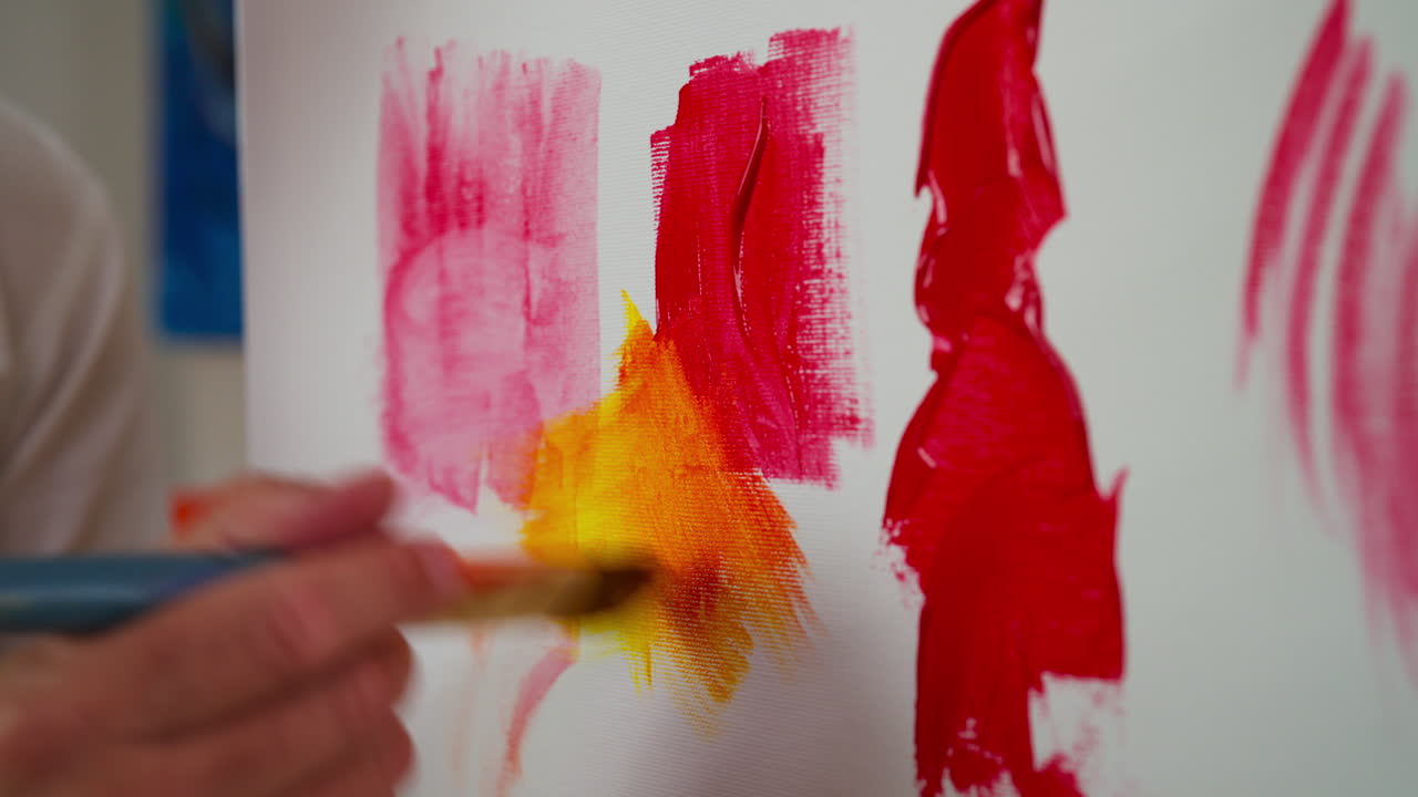 Close up shot of man hand painting on board, handheld