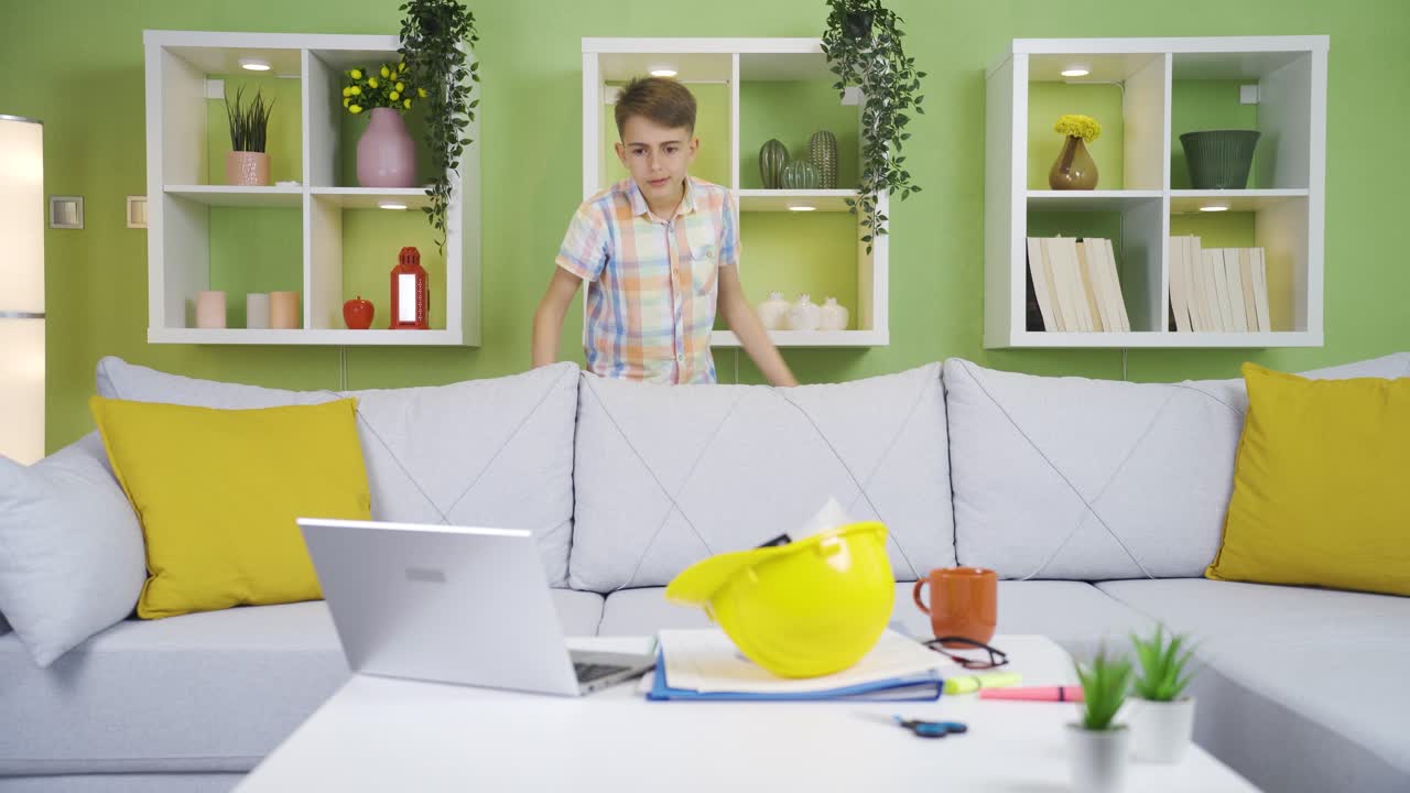 Funny boy playing with his engineer father's work items.
