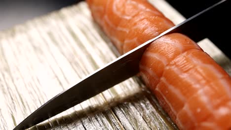 preparing salmon sushi roll