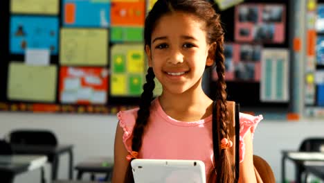 schoolgirl holding digital tablet in classroom 4k