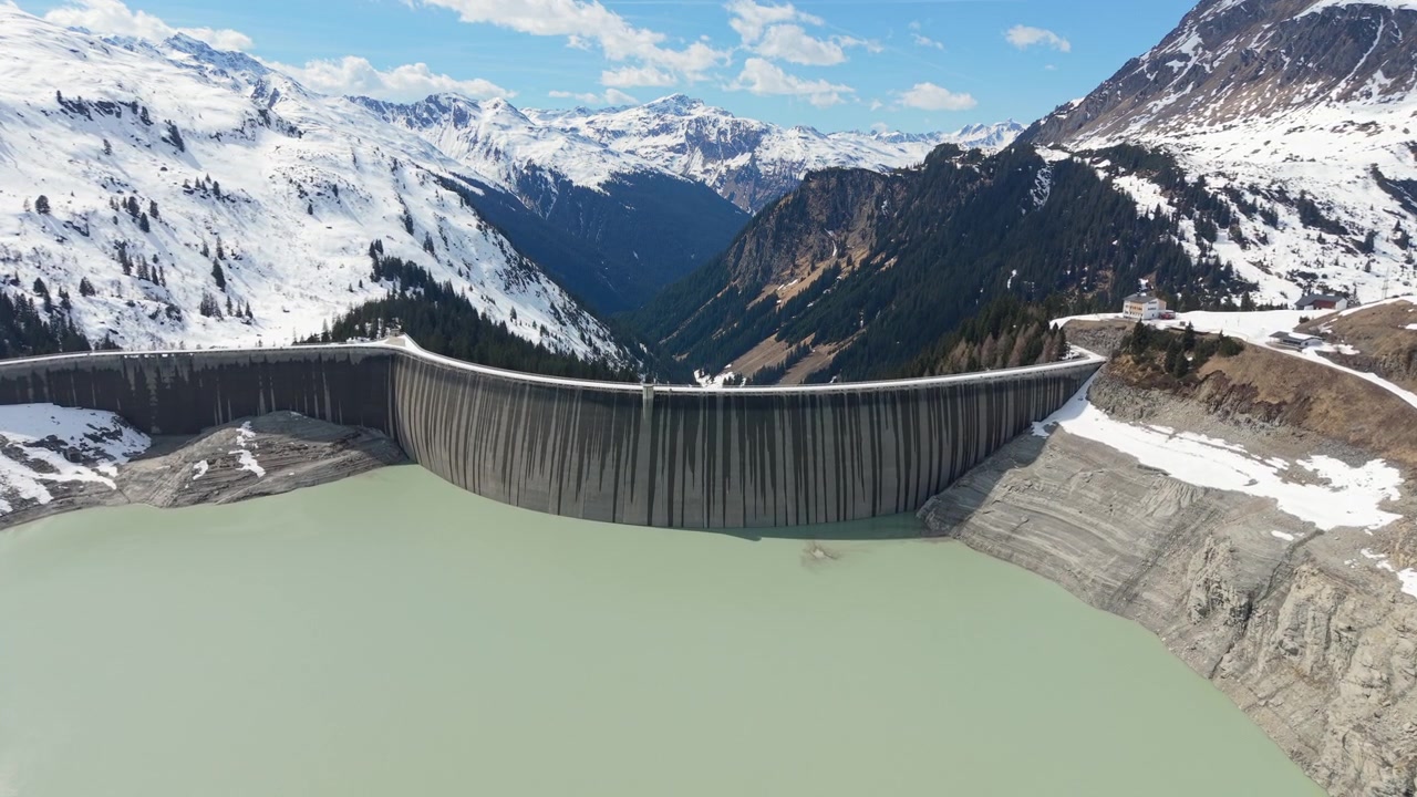 Aerial Establishing Hydroelectric Dam in Snowy Alpine Landscape