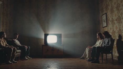 group watching tv in an old house