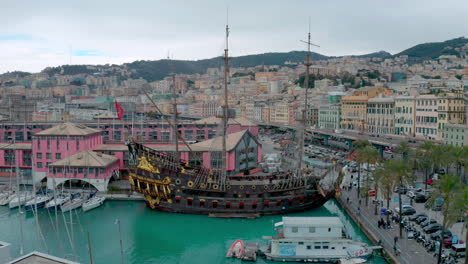 Drone-push-in-toward-The-Neptune-ship-replica-of-old-Spanish-galleon,-Genoa