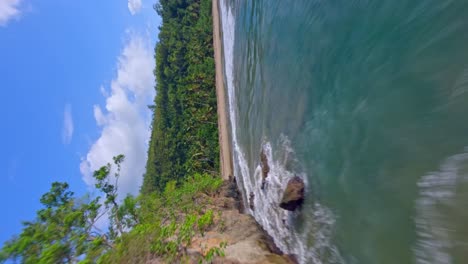 Freestyle-drone-fpv-flying-over-Playa-Caleton-beach,-La-Romana-in-Dominican-Republic