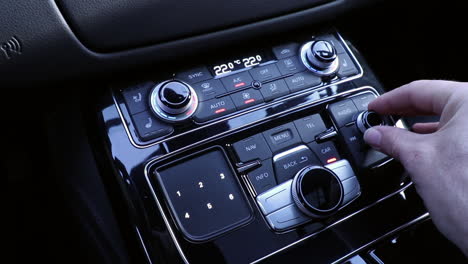 hand operating luxury car console close up