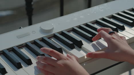 person playing a digital piano