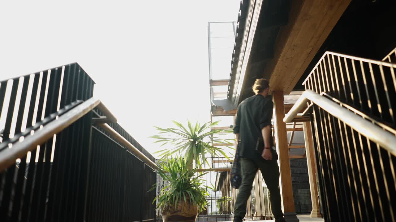 Person walking up outdoor stairs in a modern building