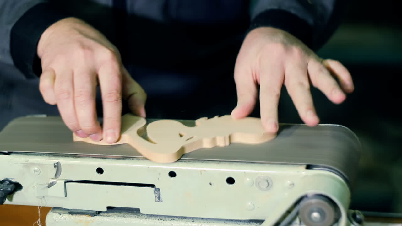 Carpenter Sanding Furniture. Close-up of male carpenter sanding wood in his workshop