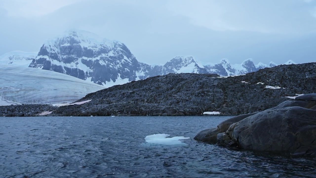 Winter Mountains Scenery in Snow and Ice, Beautiful Dramatic Blue Landscape in Antarctica on the Antarctic Peninsula, Cold Weather Conditions with Big Mountains