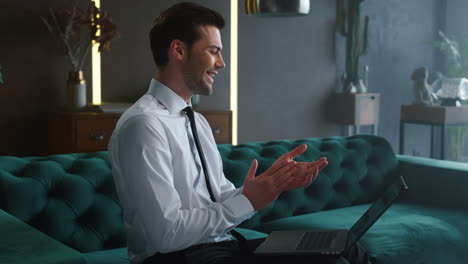 Businessman-looking-at-graphs-on-laptop-at-workplace.-Employee-enjoying-success