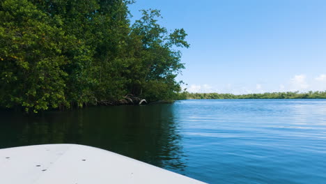 POV-of-boat-motoring-in-river-canal-in-San-Juan,-Puerto-Rico,-pan