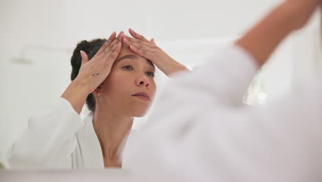 mirror, skincare and woman with hands on face