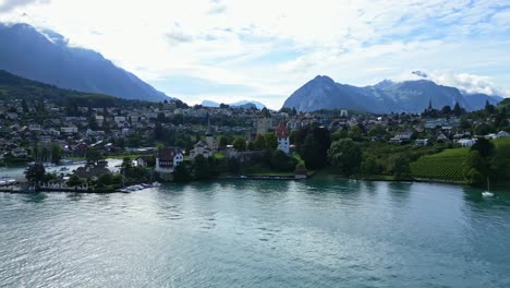 orbit drone shot of spiez castle in the canton of bern in switzerland.