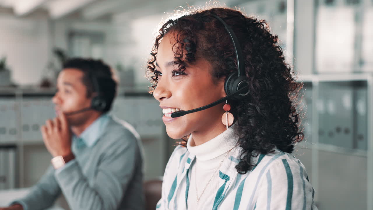 Two customer service representatives with headsets assisting customers
