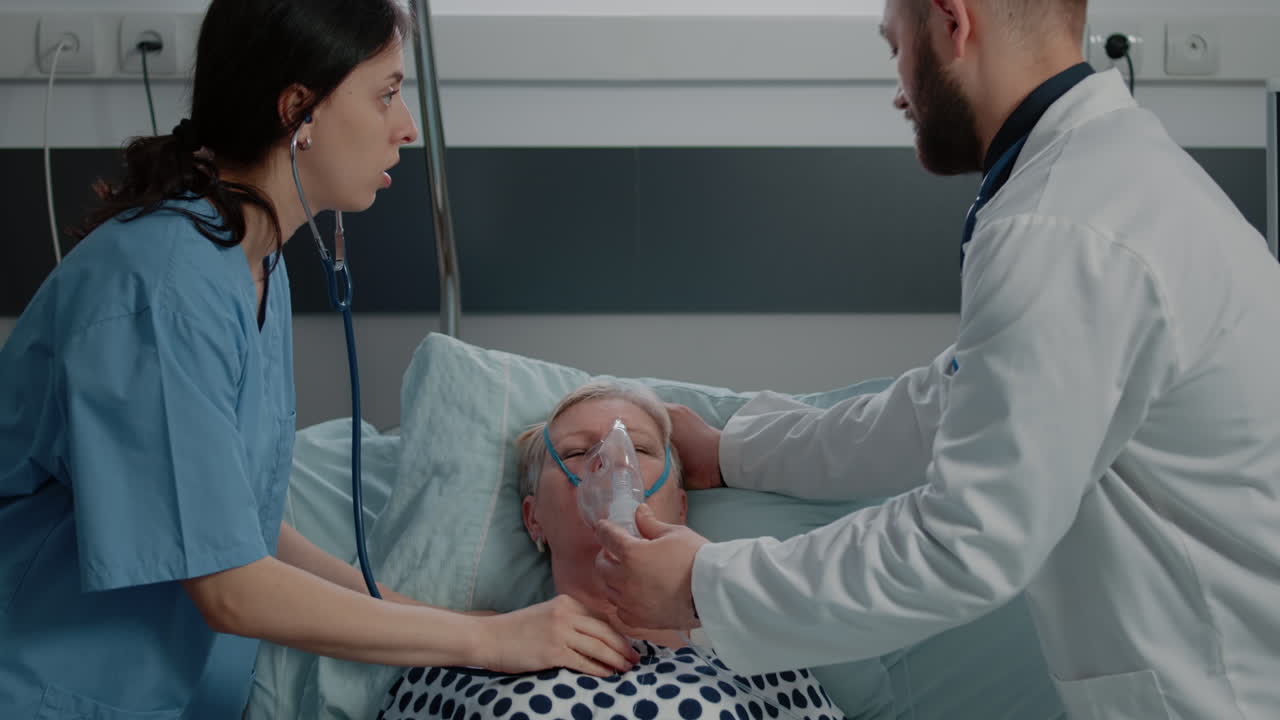 Doctor using oxygen tube mask for ill patient hyperventilating