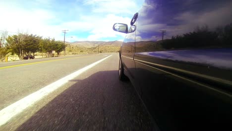 pov shot driving along a desert road at a fast speed 1