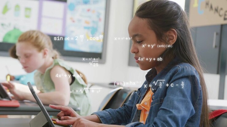 Female student typing on tablet in classroom, tapping sparking math overlays showing progress