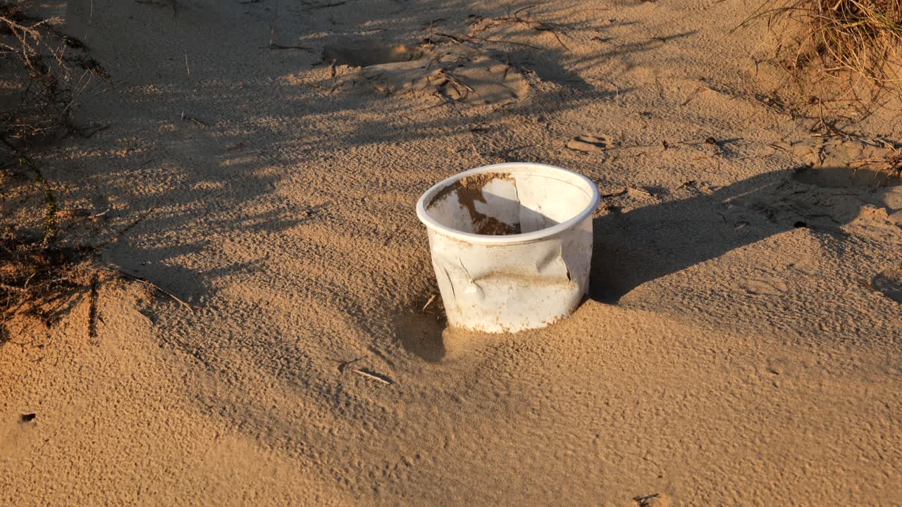 Close-up of plastic box in the desert. Plastic pollution