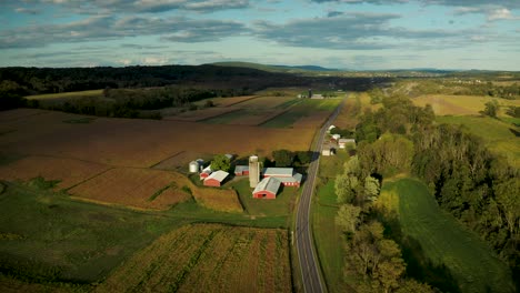 4k aerial footage of a drone pushing toward a farm on a bright, sunny day