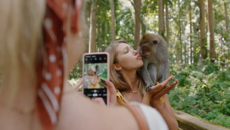 travel-woman-posing-for-photo-with-monkey-sitting-on-shoulder-best-friend-using-smartphone-photographing-playful-monkeys-sharing-wildlife-adventure