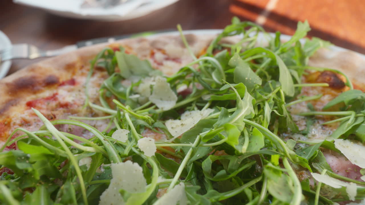 Freshly baked pizza topped with arugula and parmesan. Perfect for Italian cuisine promos or food blogs
