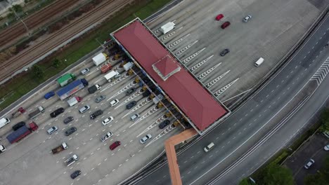 cars lining up near toll point on highway road, aerial view