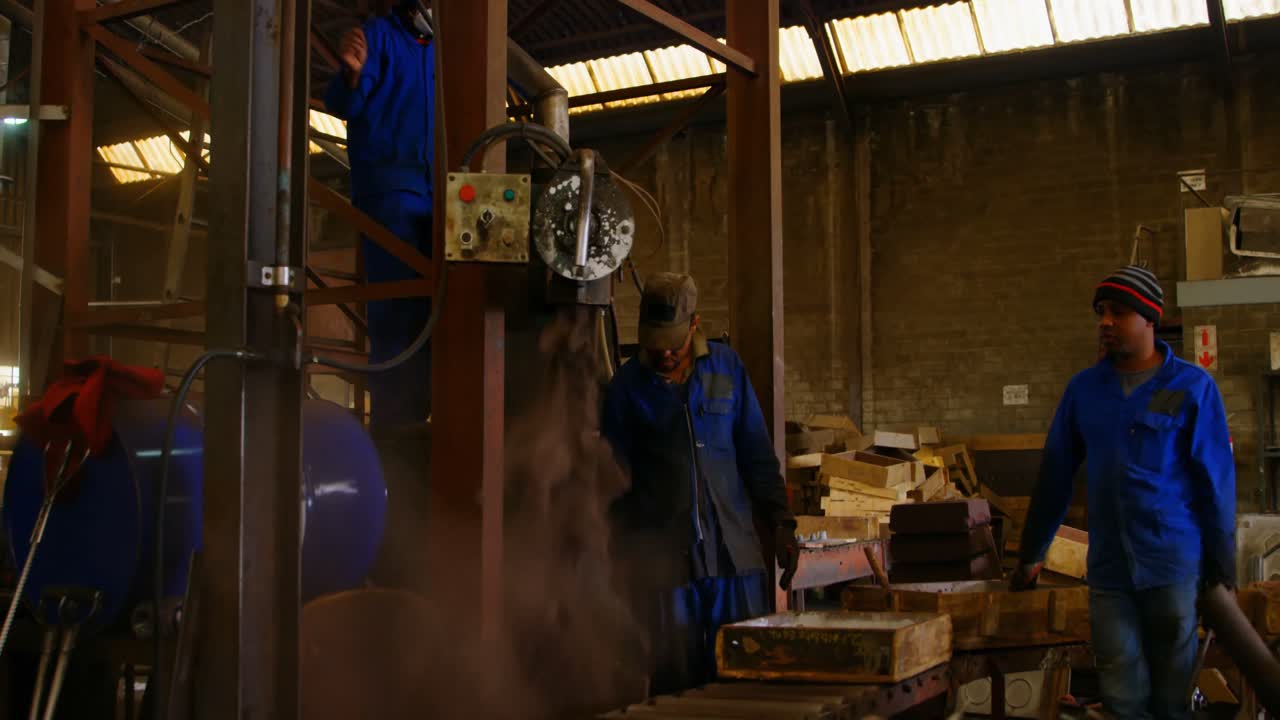 Soil falling through machine in foundry workshop 4k