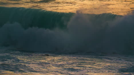 sea wave breaking shore in early morning closeup. powerful surf foaming swelling