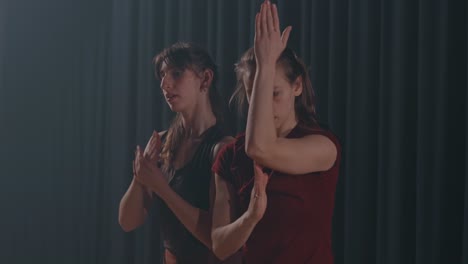 contemporary dance on empty theater stage under warm spotlight