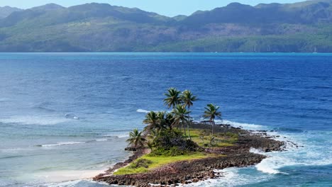 Lonely-tropical-island-with-rocky-shore-and-palm-trees-in-front-of-seascape