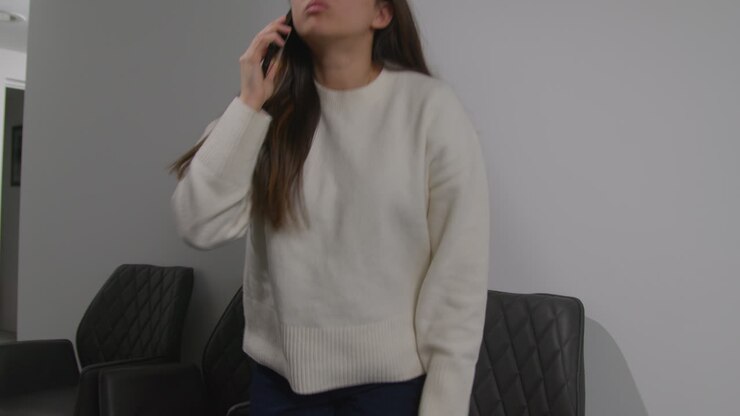 Angry Anxious Or Stressed Woman Having Argument On Mobile Phone At Work In Office Building