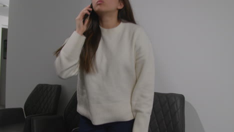 angry anxious or stressed woman having argument on mobile phone at work in office building