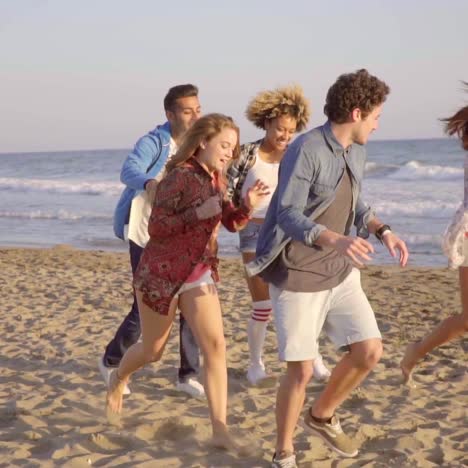 jóvenes corriendo en la playa