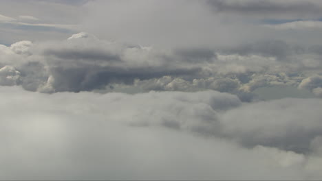 Aerial-shot-in-between-white-fluffy-clouds-with-clouds-above-and-below