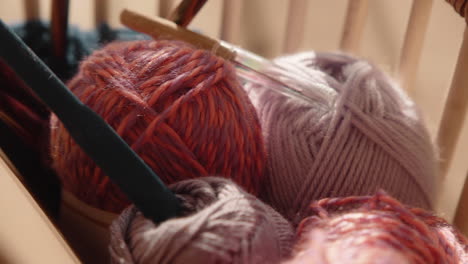 detail of knitting equipment in a basket wool and needles sunlit living room 4k