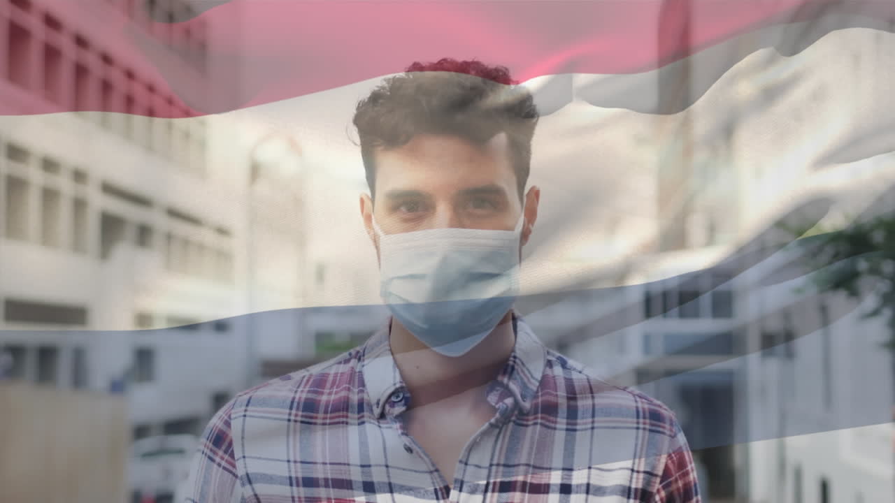 코로나19 전염병 기간 동안 마스크를 쓰고 있는 남성 위에 날아다니는 네덜란드 국기의 애니메이션