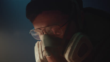 a bombmaker assembles a bomb in his workshop at night