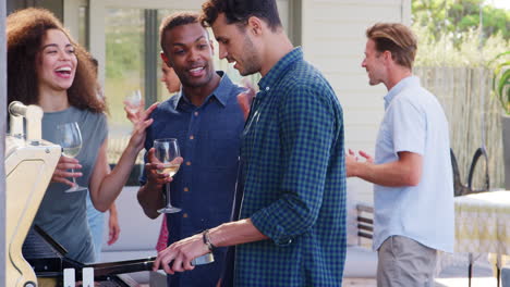 Group-Of-Friends-Enjoying-Barbecue-At-Home-Together